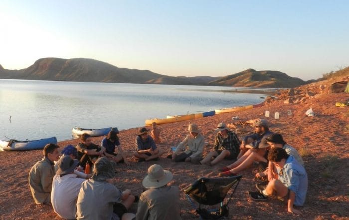 Students sit outside while learning