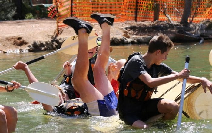 Student falling off of kayak on an expedition with AdventureWorks WA