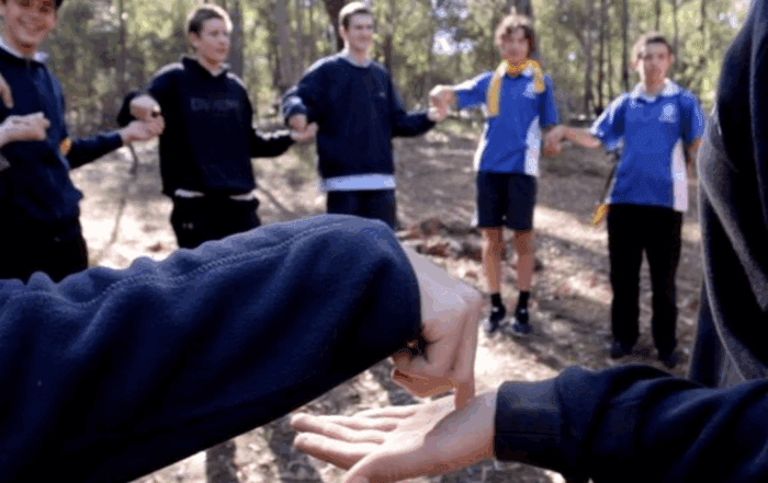 Students stand in a circle playing a connection activity